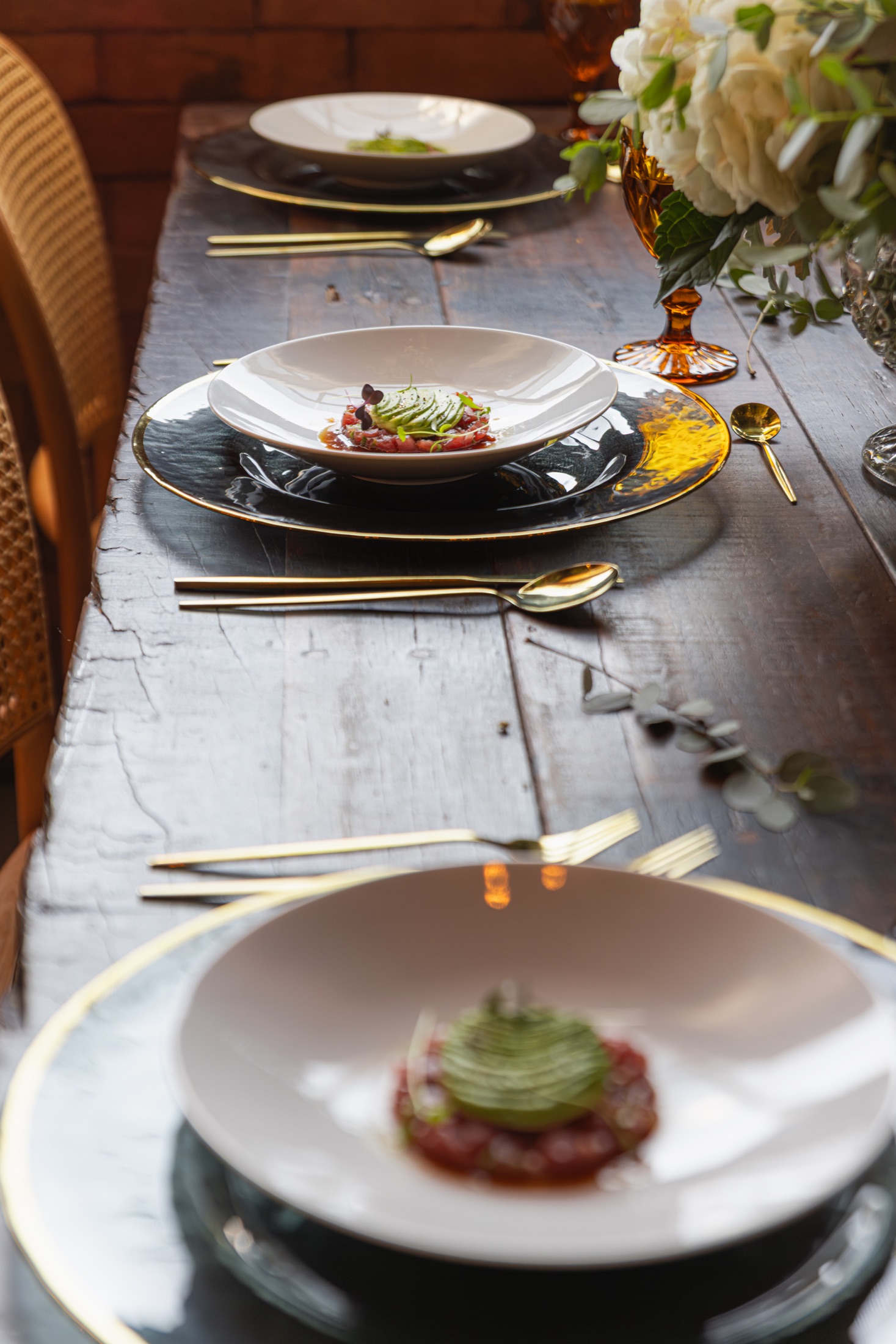 Refined avocado course in a wide white bowl